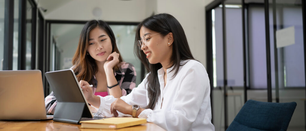 Two high school interns work together on an internship project