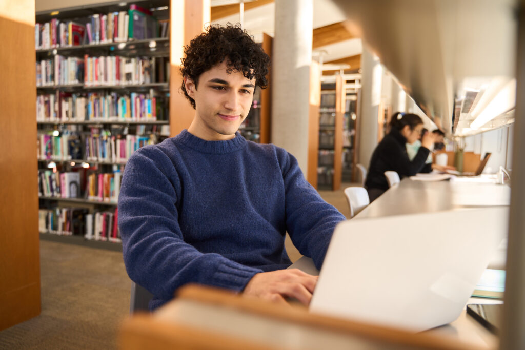 Student working on a humanities research project in a special archive library