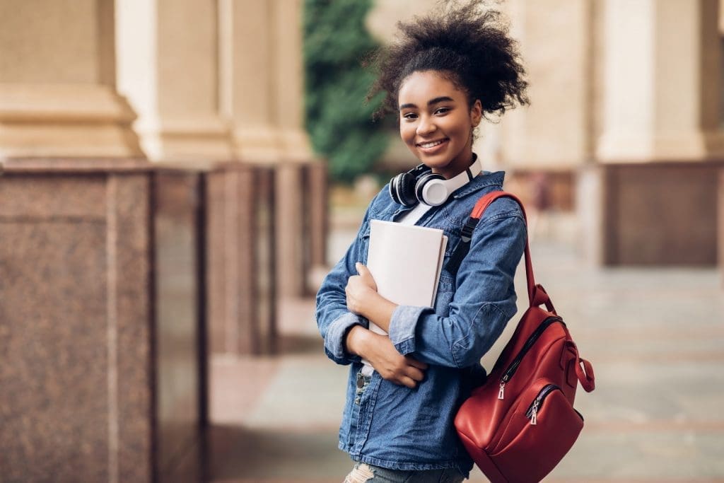 student holding books
